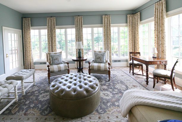 Stones Crossing Sitting Room Furnished with a large tufted ottoman and traditional area rug
