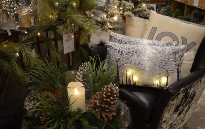 Natural pinecones, white candles, and a touch of greenery for decorating for the holidays