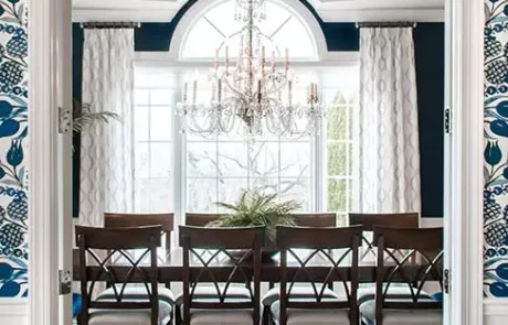 Wood Dining Room Table and Chairs with a Chandelier above in a Navy Blue and White Dining Room Design